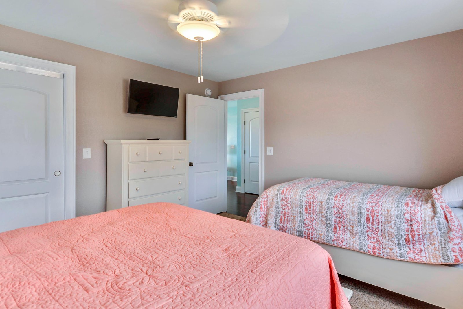 Drift off in your peaceful bedroom with two comfortable beds, perfect for sharing your stay with family or friends. Soft lighting and plenty of storage await you.