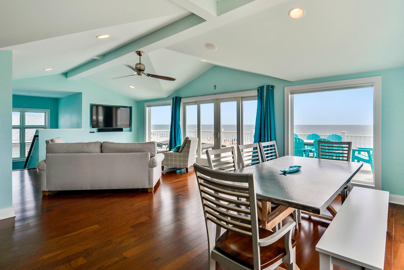 Bright open-concept living space with floor-to-ceiling ocean views, comfortable seating for your group, and coastal charm. Let the rhythm of the waves set your vacation pace.