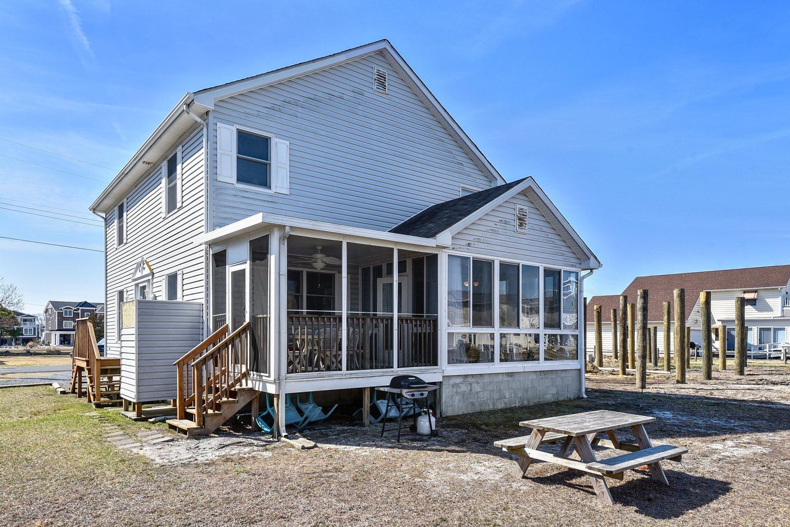 A charming waterfront cottage with a screened porch and outdoor picnic area awaits your coastal getaway.