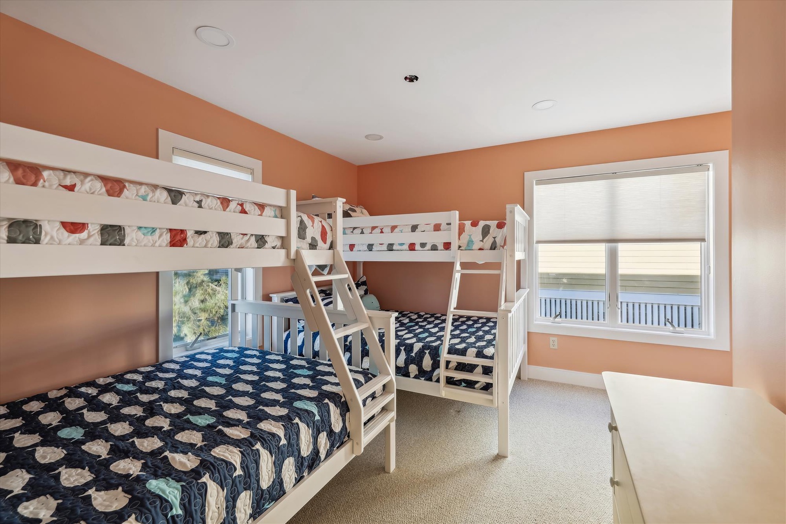 Bright and cheerful bunk room with multiple sleeping spots—perfect for kids or groups traveling together. Cozy bedding and natural light create a restful retreat.