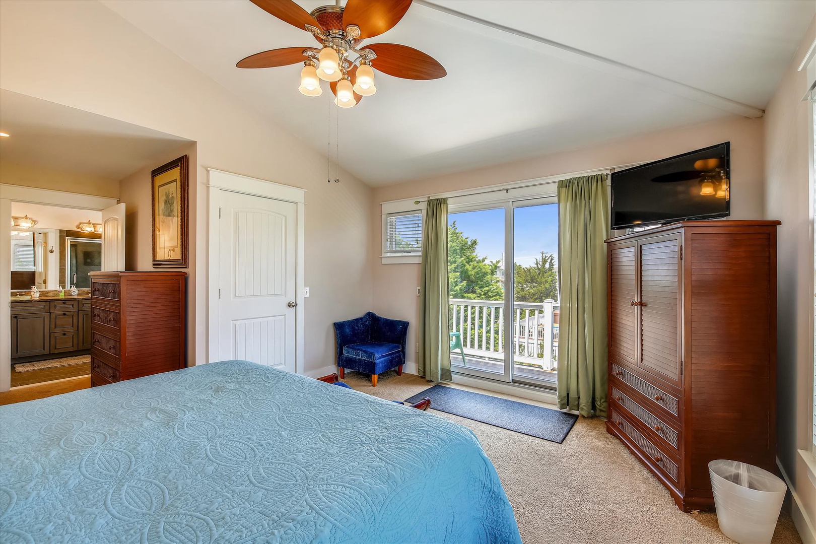 Wake up in this bright, comfortable bedroom with a ceiling fan overhead and your own private balcony access. Sunlight streams through the glass doors, inviting you to step outside and start your day refreshed.
