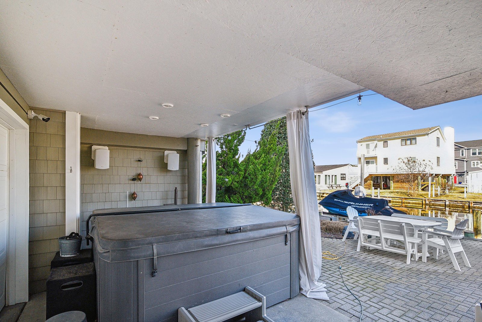 Unwind in your private hot tub on this covered patio, where relaxation meets waterfront views and easy boat access.