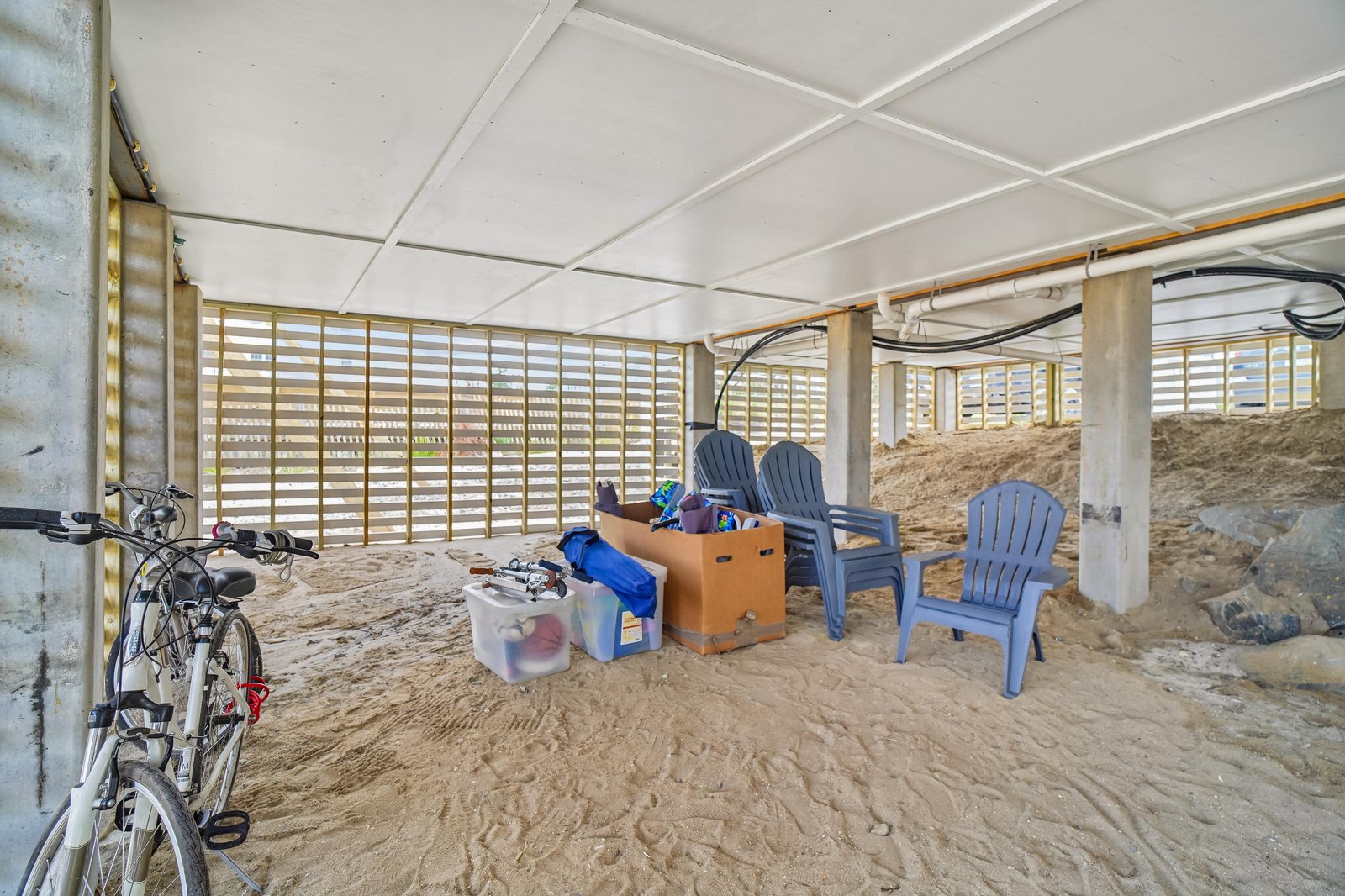 Secure, shaded storage area beneath the property offers your personal space for beach gear, bikes, and outdoor equipment—all steps from the sand.