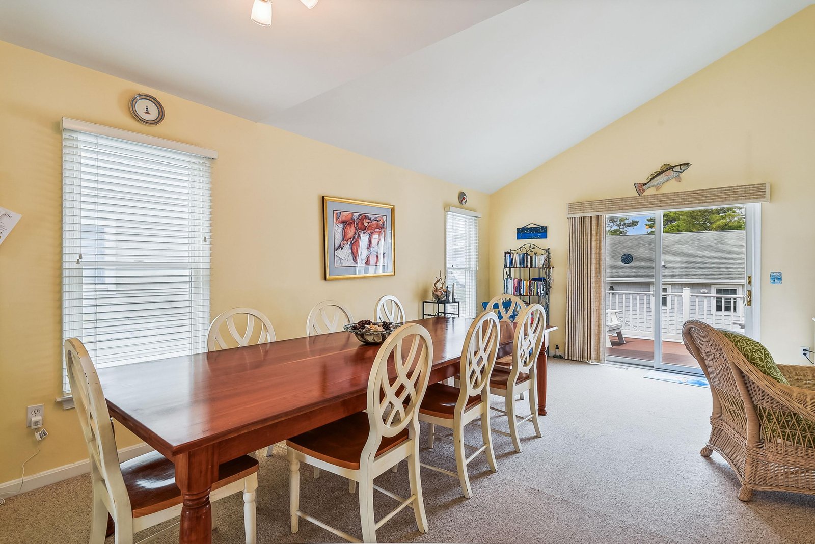 Step into your bright dining space, where a beautiful table awaits your family meals. Natural light pours in from generous windows, and glass doors open to your private deck—perfect for morning coffee or evening breezes.