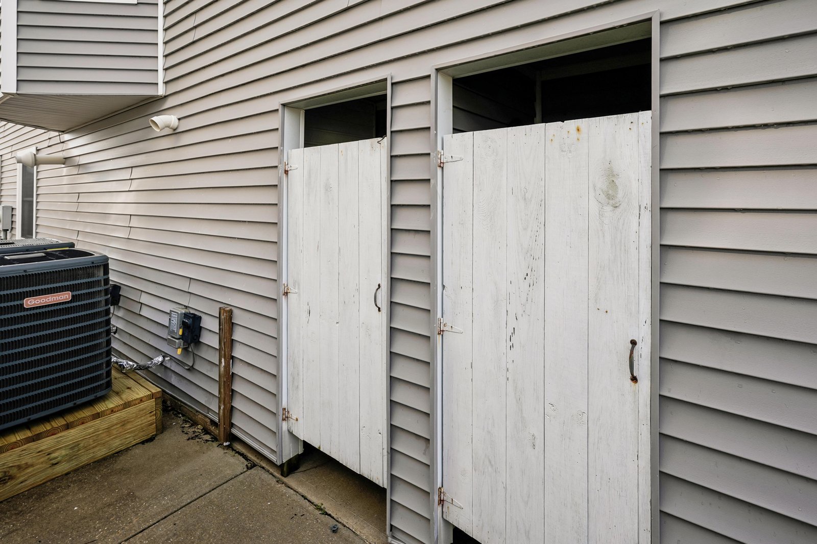 Exterior storage areas and climate control unit positioned along the property's side, providing functional outdoor space and comfortable year-round temperature regulation.