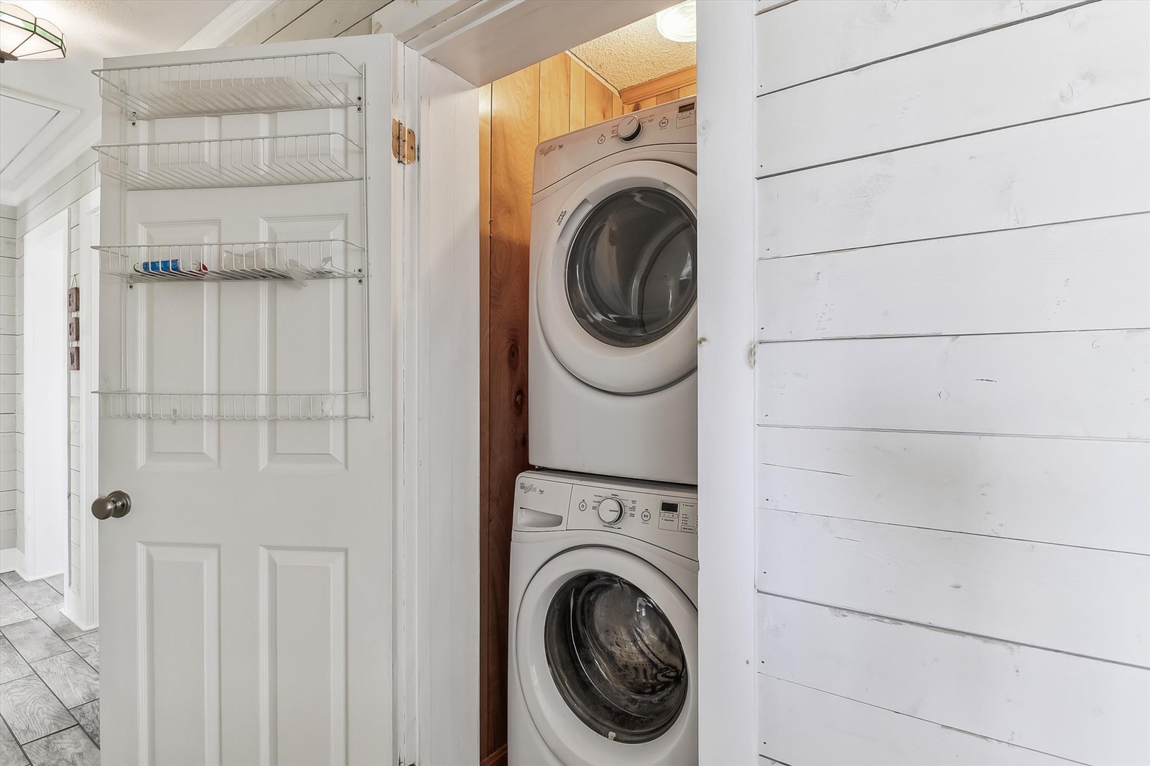 Your laundry routine stays effortless with a stacked washer and dryer tucked conveniently into a bright, cottage-style closet—no lugging clothes to shared facilities.