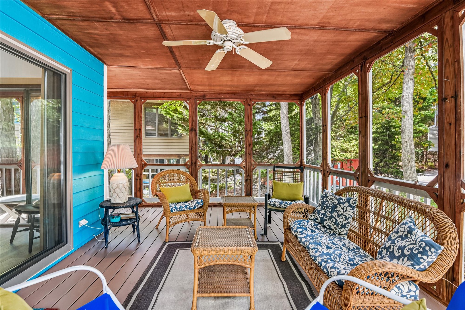 Unwind on your screened porch with wicker seating and ceiling fan, where morning coffee meets garden views through large windows.
