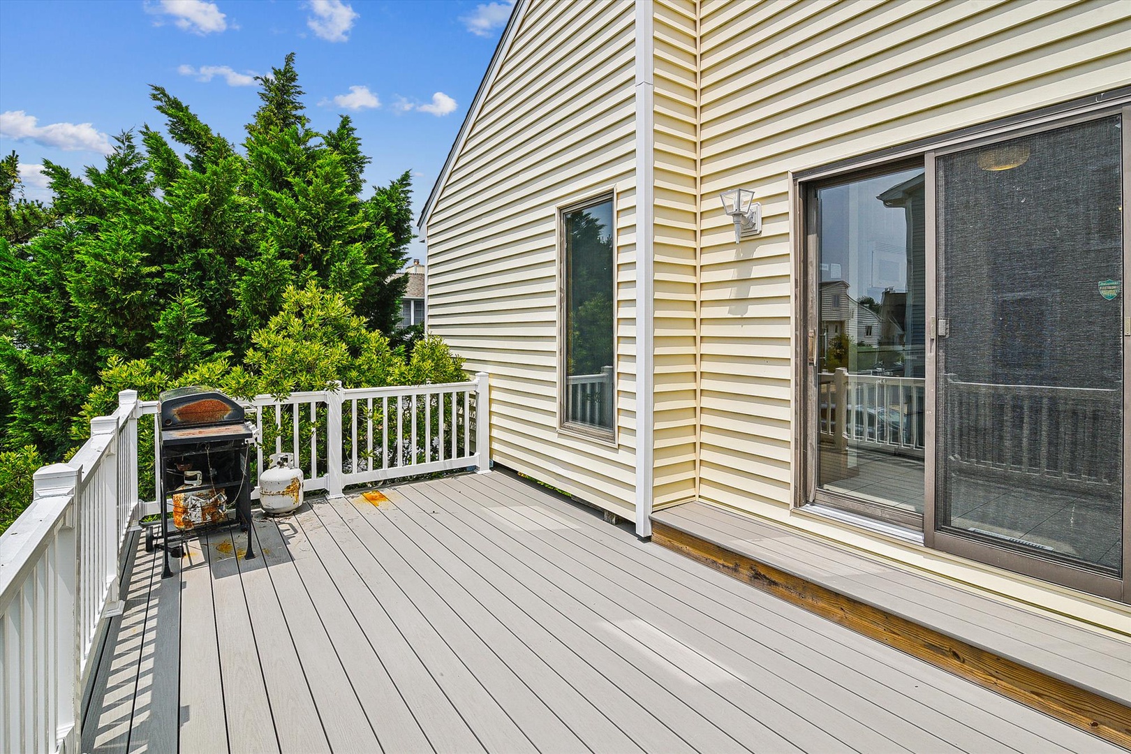 Step onto your private deck with grill and enjoy sunny days surrounded by lush greenery, with plenty of space for outdoor dining and relaxation.