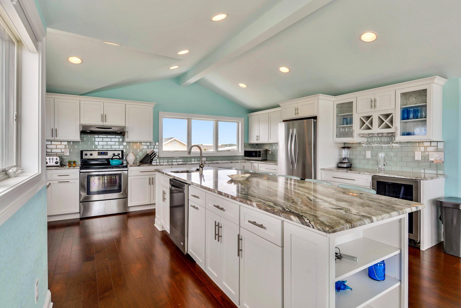 Step into your fully equipped dream kitchen with gleaming granite countertops, stainless steel appliances, and abundant cabinet space—perfect for preparing meals together while soaking in natural light through vaulted ceilings.