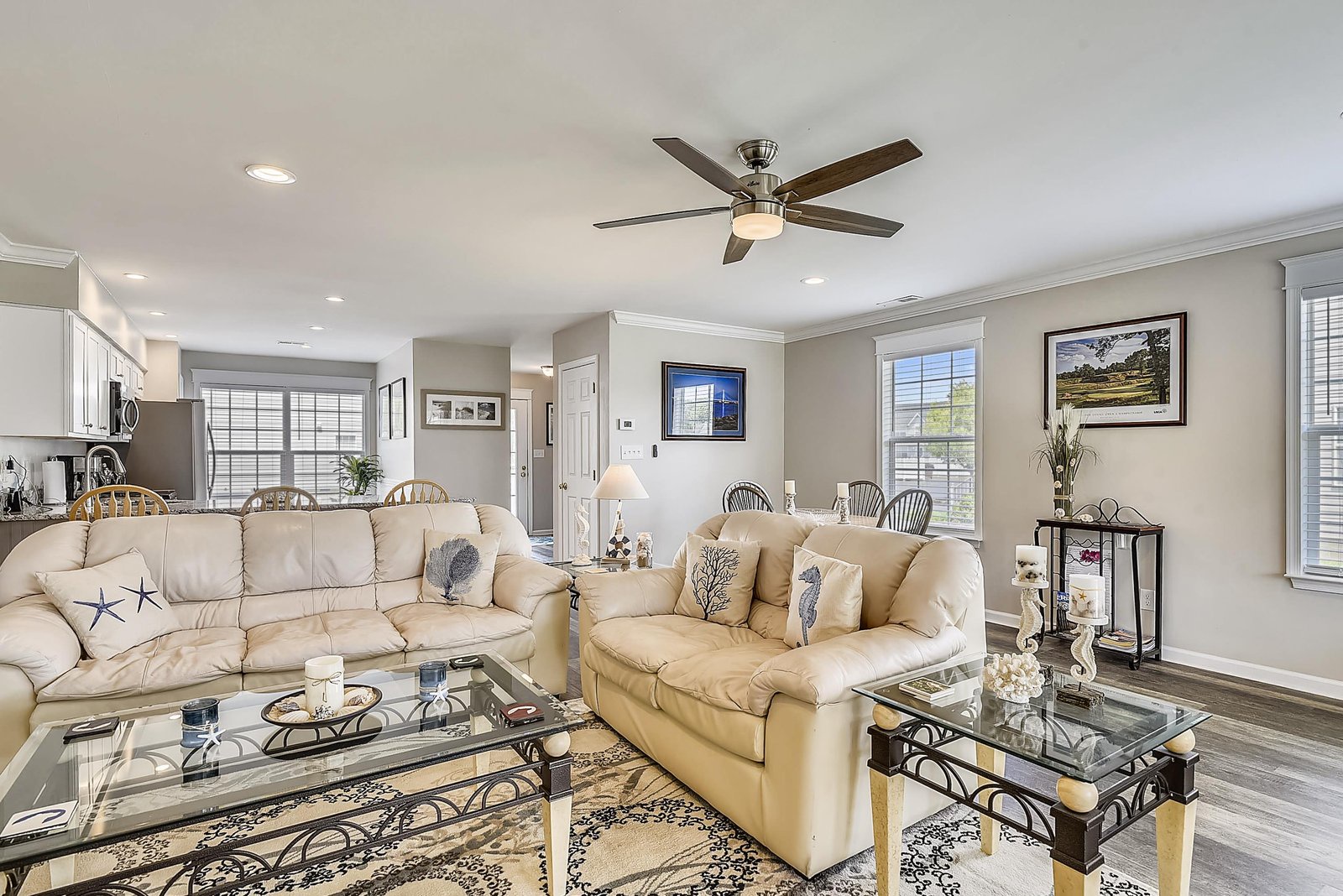 Sink into plush leather sofas in your open-plan living space, where coastal touches and natural light create a calm, welcoming retreat.