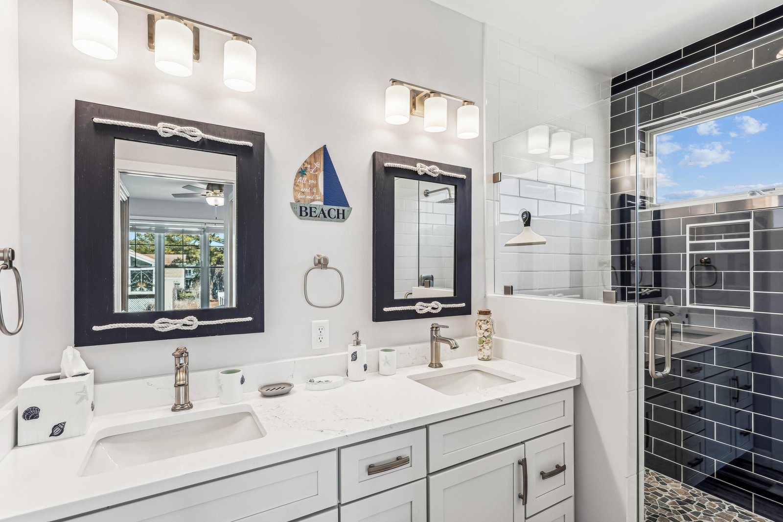 Step into your coastal retreat where nautical touches meet modern comfort. The dual vanity provides plenty of space, while a refreshing tiled shower awaits after sandy beach adventures.