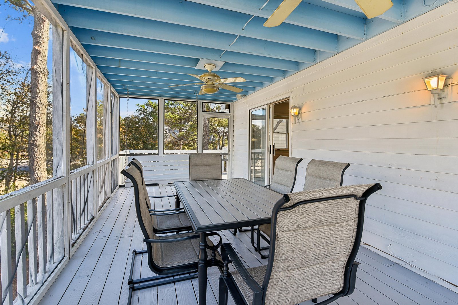 Dine al fresco on your private screened-in porch, where ceiling fans and peaceful tree views create the perfect backdrop for relaxing meals and morning coffee.