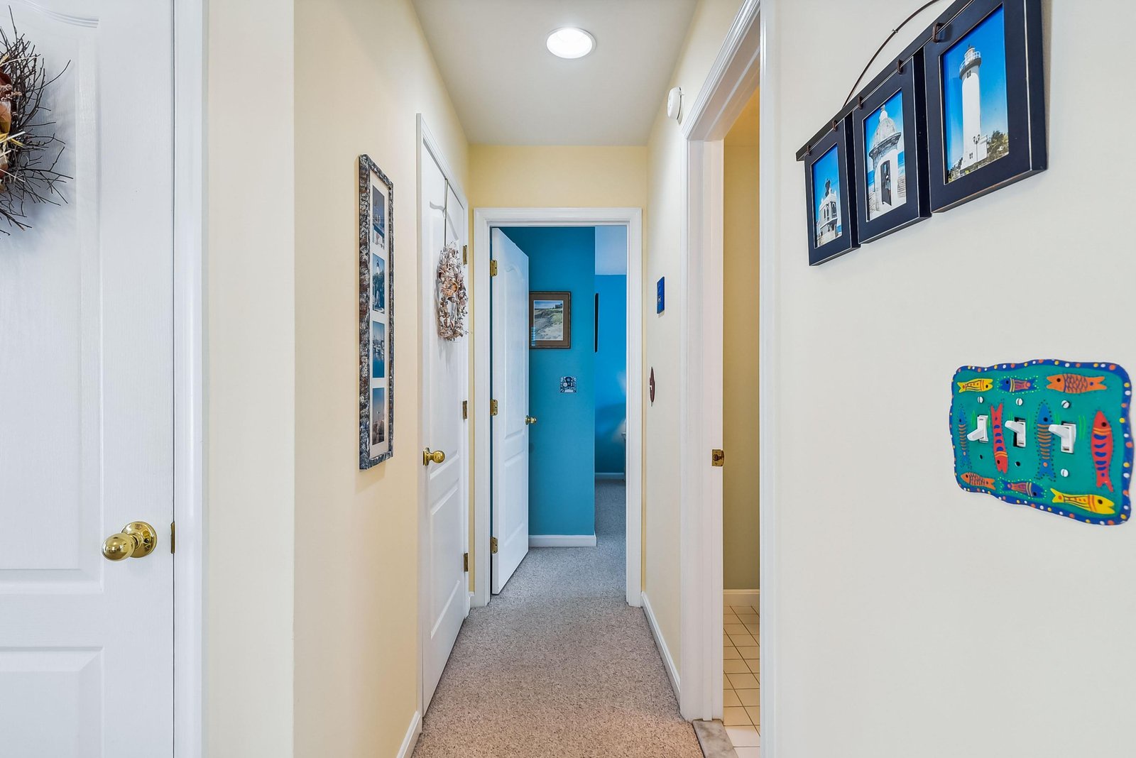 Bright hallway connects your private spaces with cheerful coastal touches and soft carpeting underfoot.