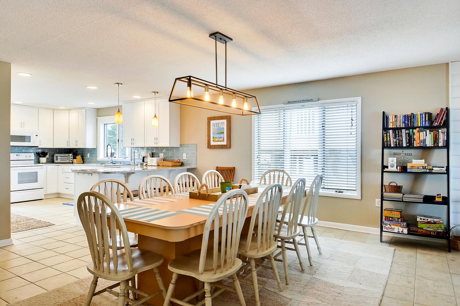 Gather around the spacious dining table with seating for everyone, bathed in warm light and opening directly to your fully equipped kitchen—perfect for home-cooked meals and laughter.