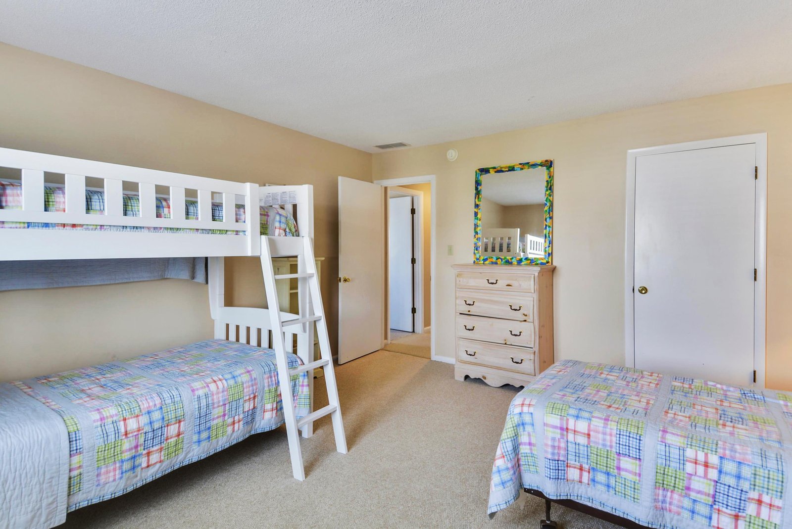 Your cheerful bunk room awaits, perfect for kids or friends. Soft pastels, cozy quilts, and a charming mirror make everyone feel right at home.
