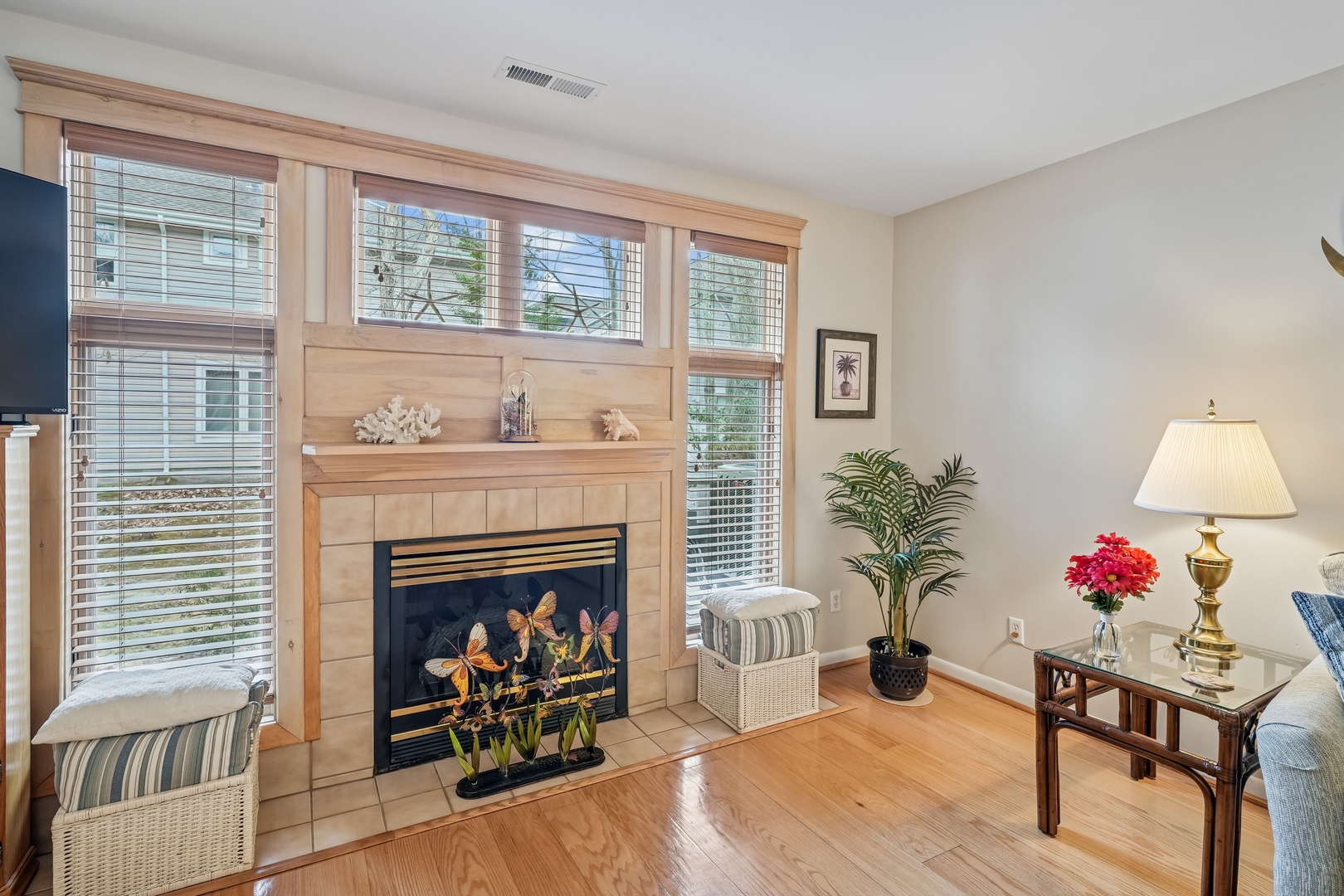 Curl up in your elegant living room, where warm wood floors and a stunning fireplace create the perfect retreat for cozy evenings.