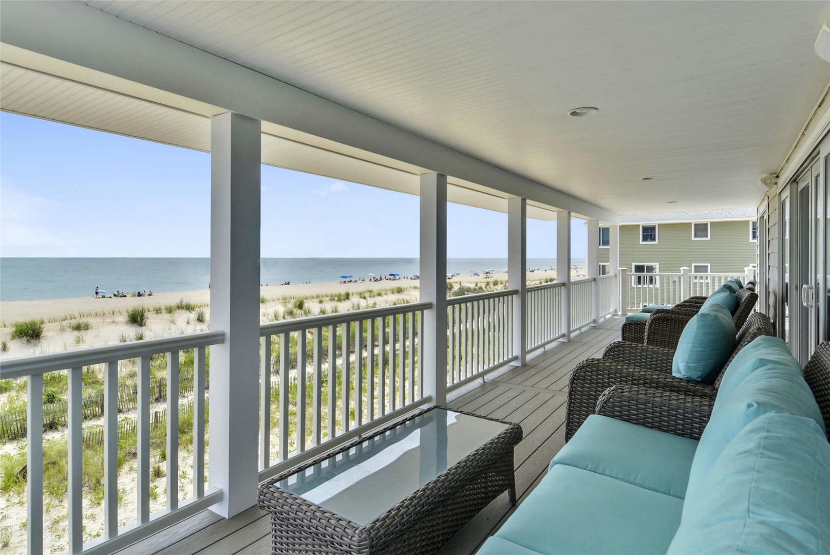 Sink into plush seating on your private covered deck and gaze out at the sparkling ocean and sandy beach—your perfect spot for morning coffee or evening relaxation.