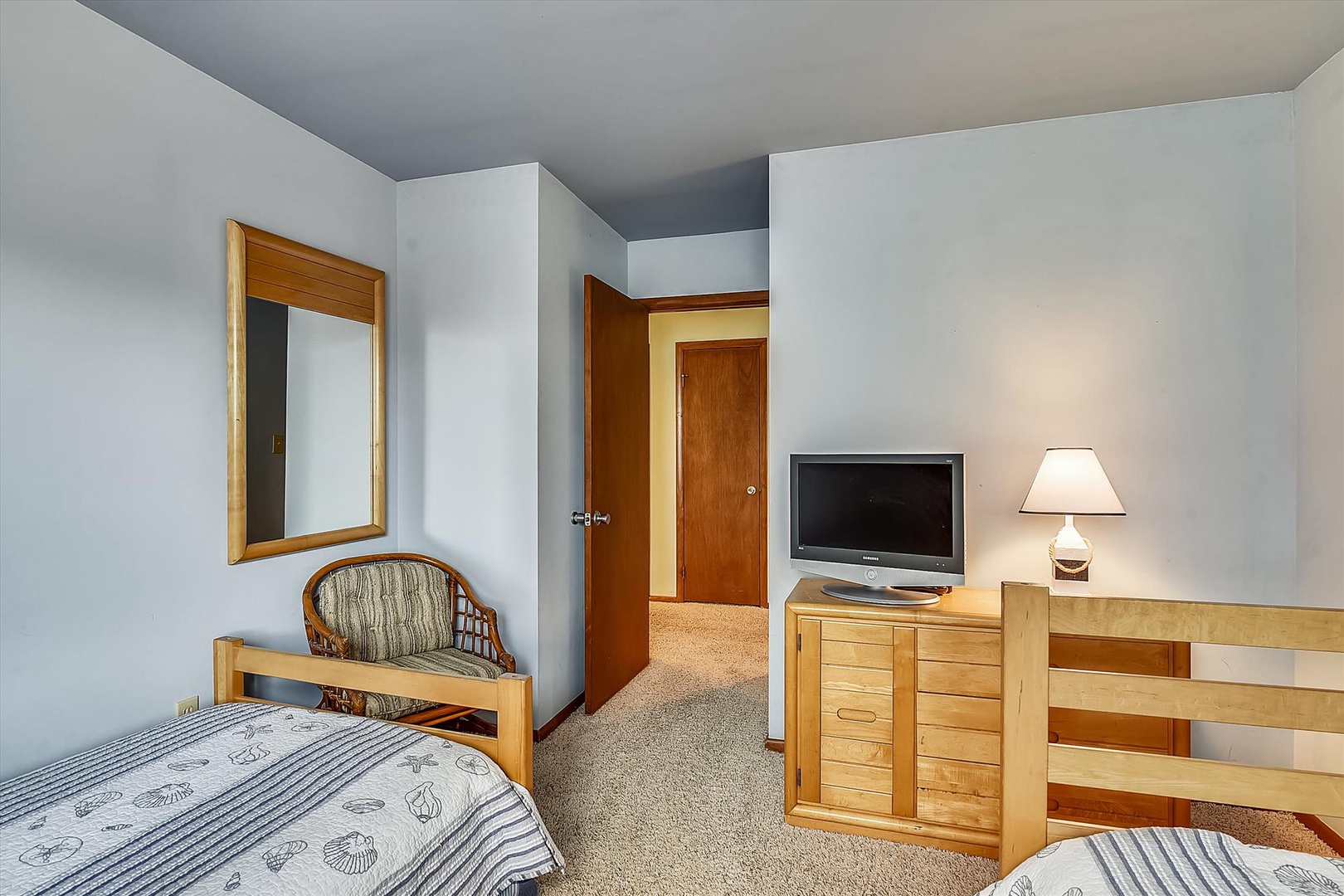 Your comfortable sleeping space features twin beds, a TV for entertainment, and warm wood furnishings that create a welcoming retreat after your day's adventures.