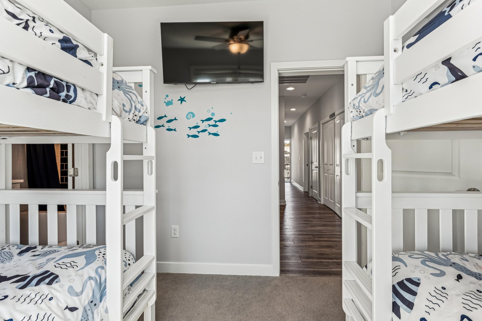 Your kids will love this cheerful bunk room with twin bunk beds and playful sea-themed decor, complete with a ceiling fan and TV for downtime fun.