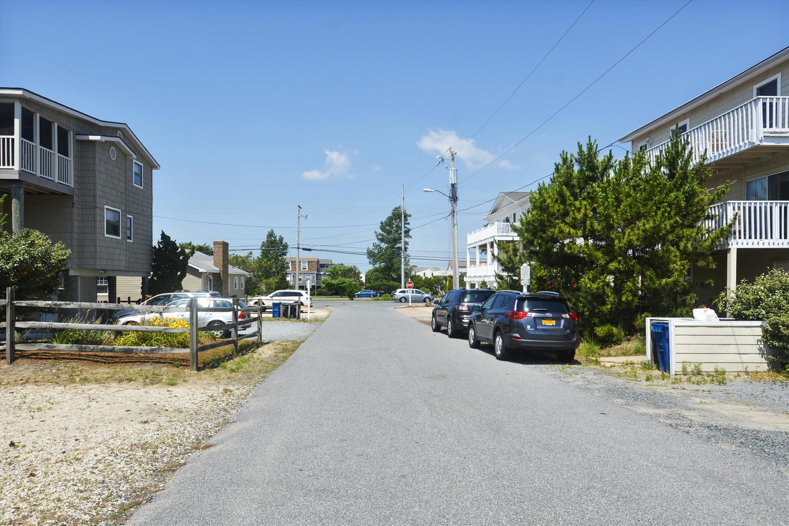 A quiet coastal street with beach homes and nearby parking, located within a peaceful residential neighborhood close to the shore.