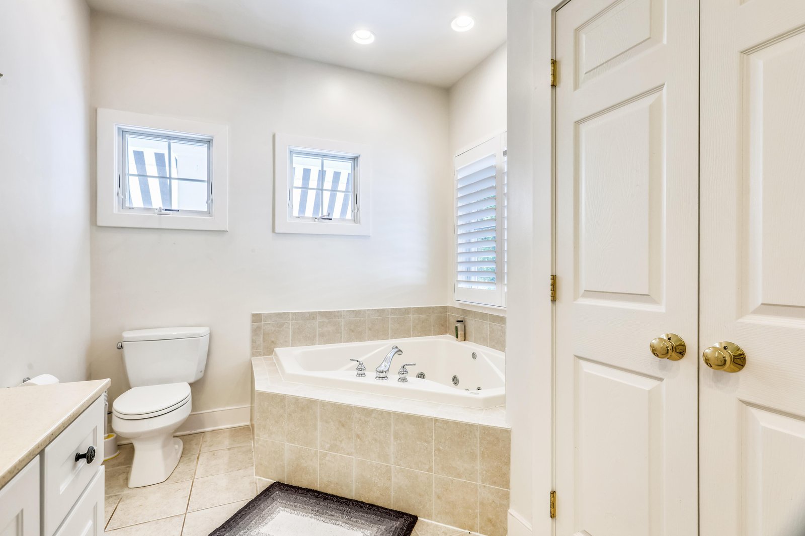 Sink into the jetted tub after a day of exploring—this bright bathroom invites you to unwind with plenty of natural light and a soothing, spa-like feel.