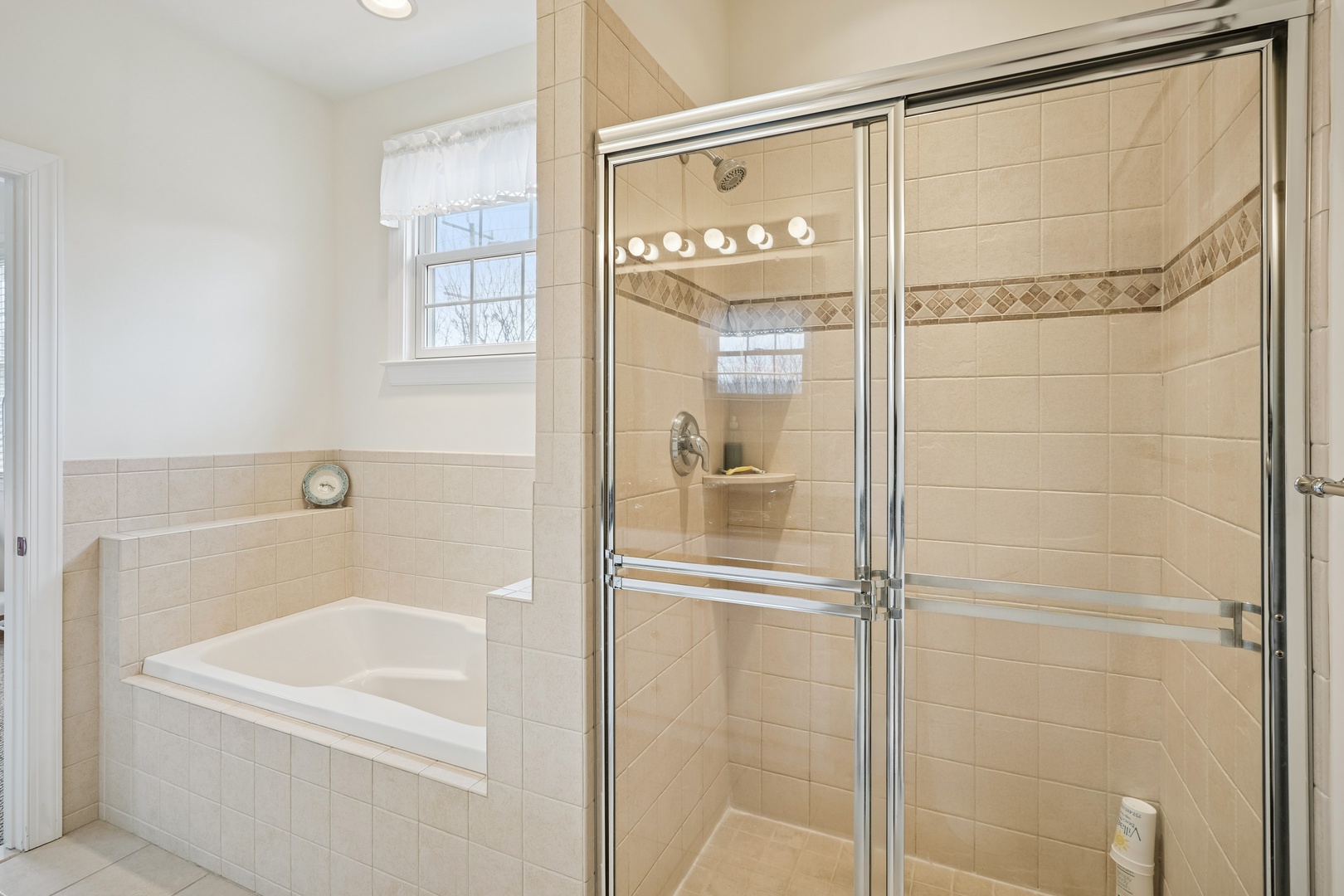 Unwind in your private spa-like bathroom with a deep soaking tub and spacious glass shower, perfect for relaxing after your adventures.