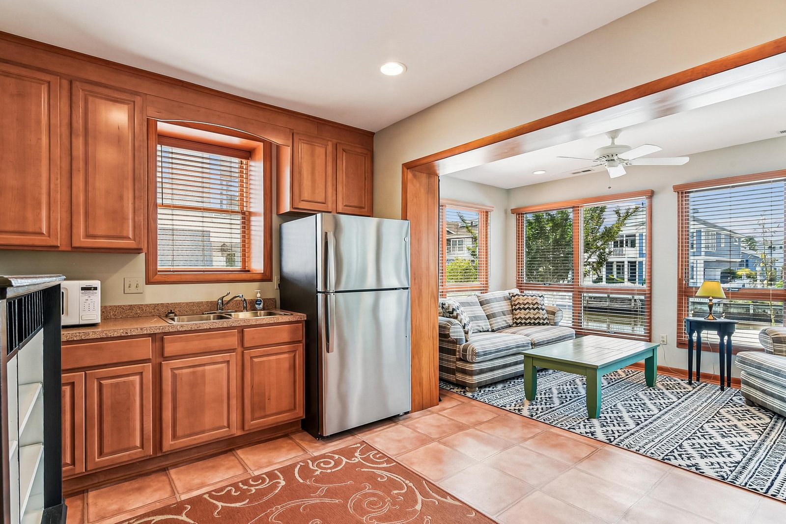 Step into your bright, open-plan space where the kitchen flows seamlessly into a sunlit living area. Natural light pours through windows, inviting you to relax with your morning coffee or unwind after a day of exploring.