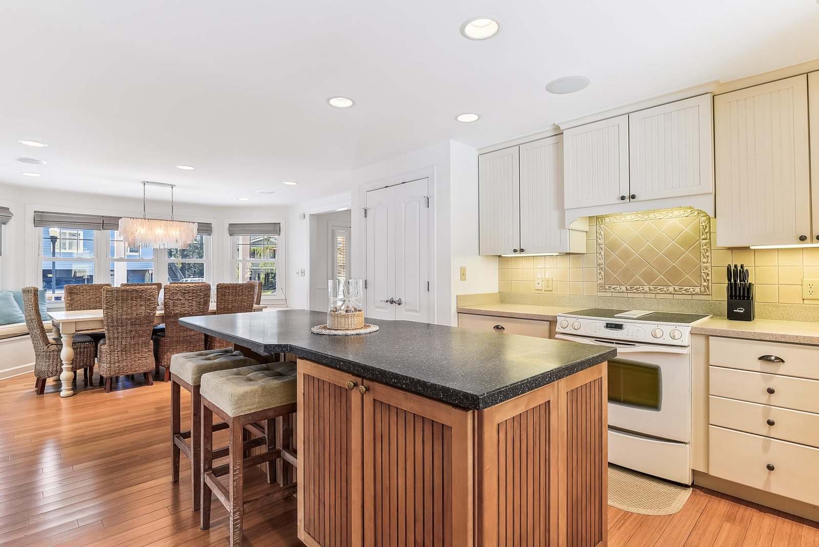 Step into your inviting kitchen and dining space, where warm wood floors and a spacious island invite you to gather and create delicious memories together.