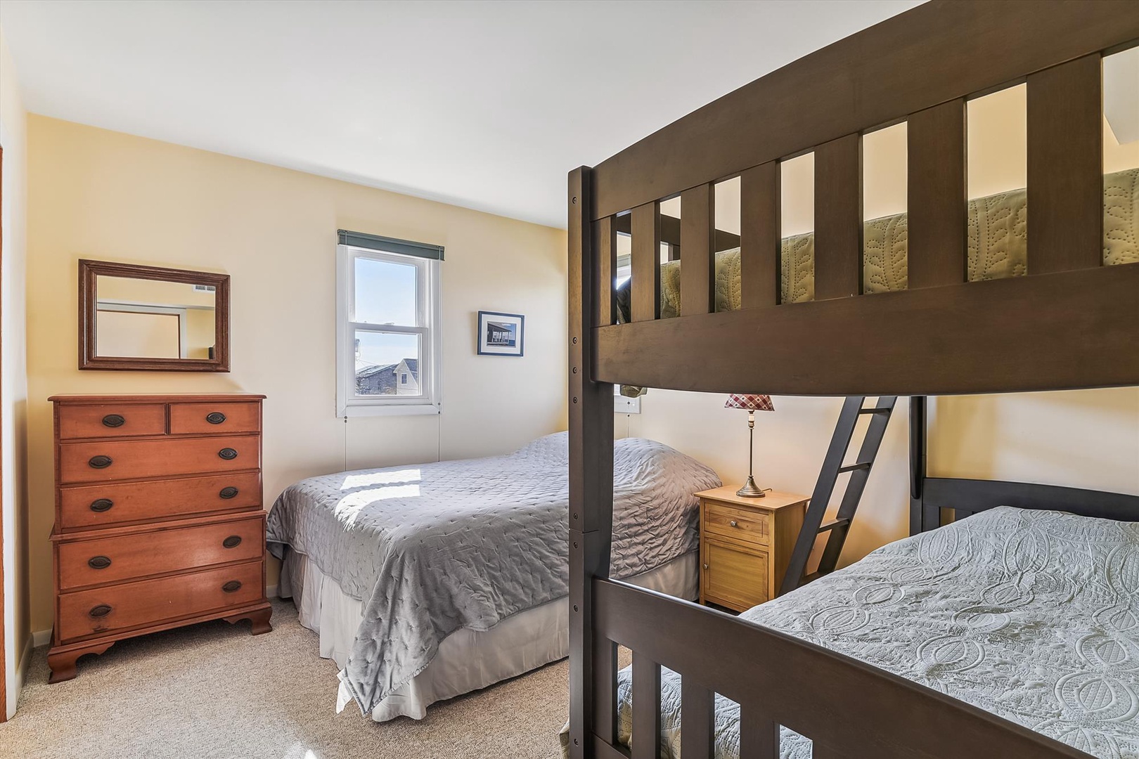 Your comfortable bedroom features a cozy bunk bed and a queen bed, perfect for families or friends traveling together. Natural light and thoughtful furnishings create a restful retreat.