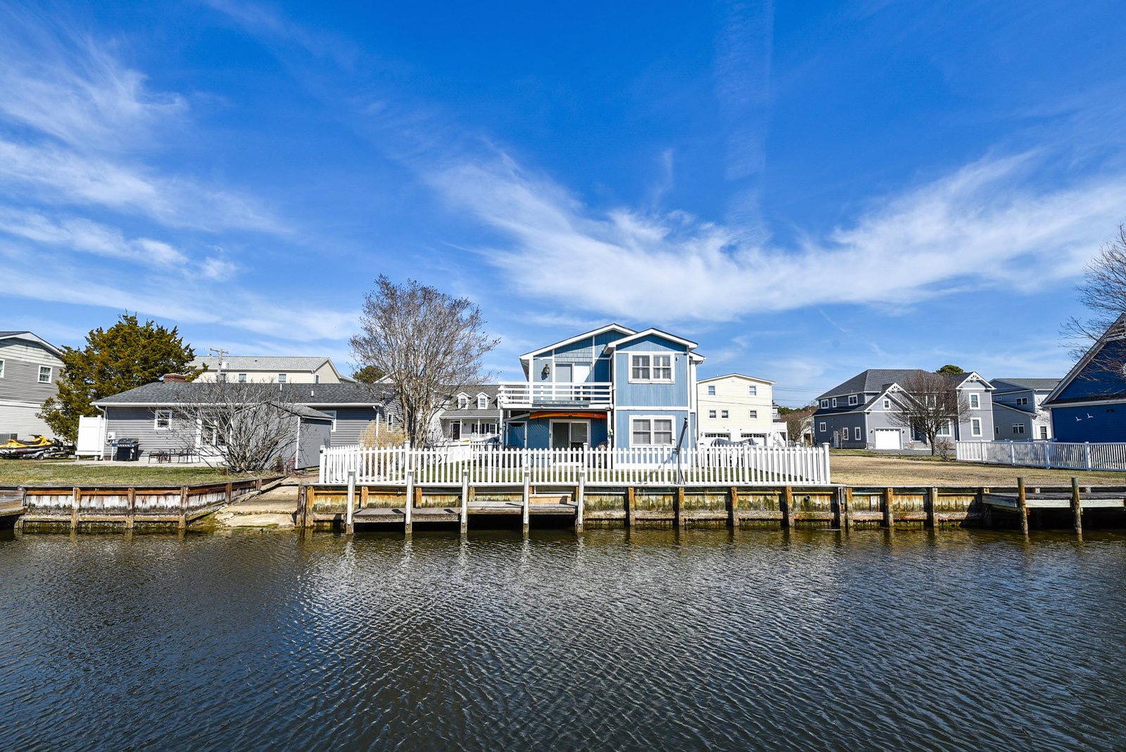 Charming waterfront property with private dock access and classic coastal architecture in a peaceful neighborhood setting.