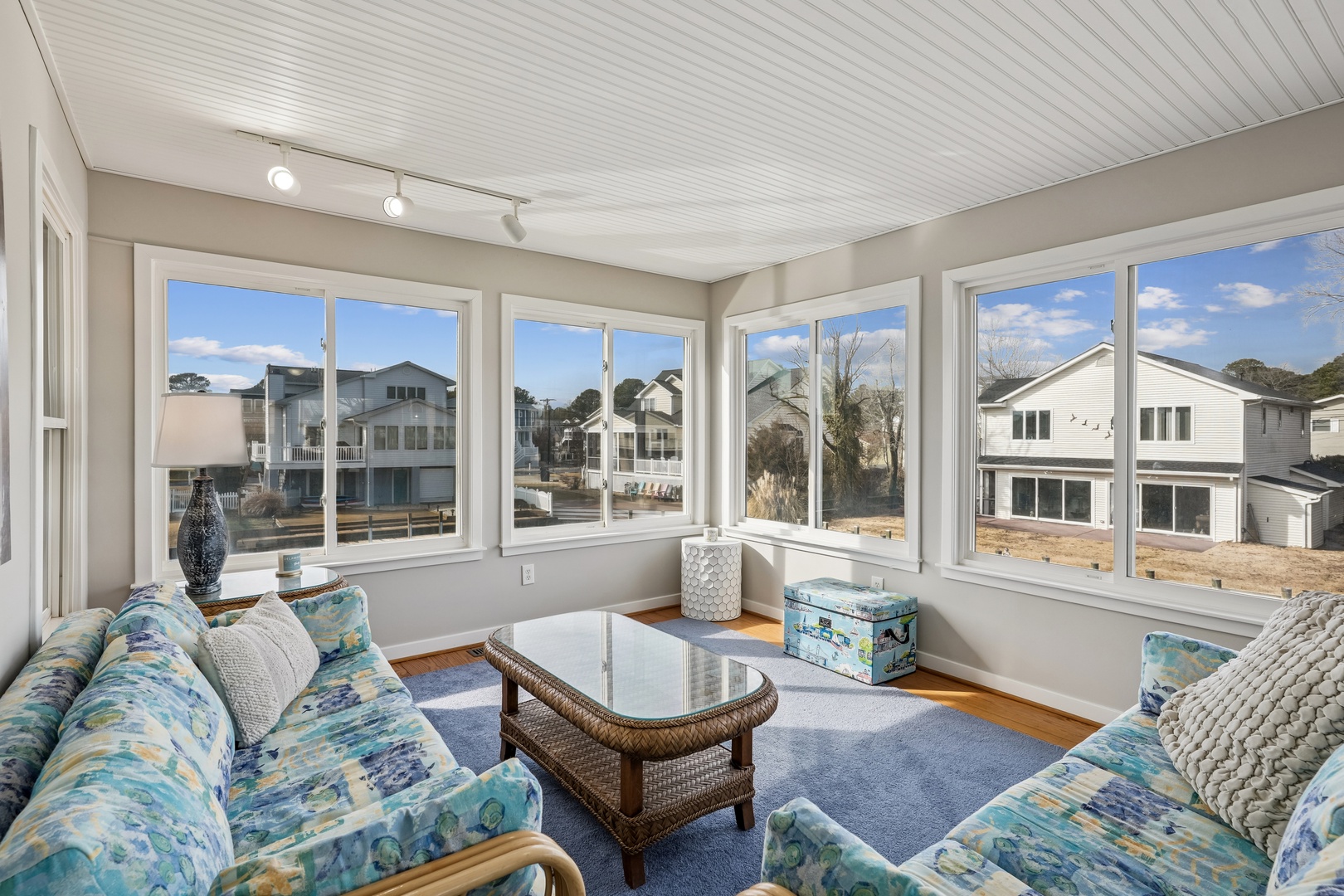 Relax in your bright sunroom with panoramic windows framing peaceful neighborhood views.