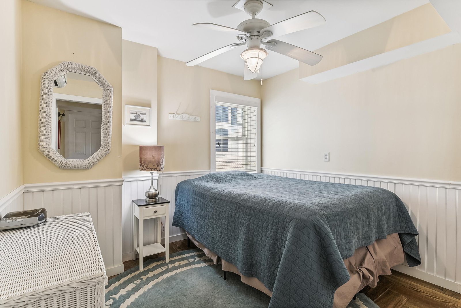 Settle into your cozy bedroom, where soft coastal colors and charming wainscoting create a calm, restful retreat perfect for unwinding after your adventures.
