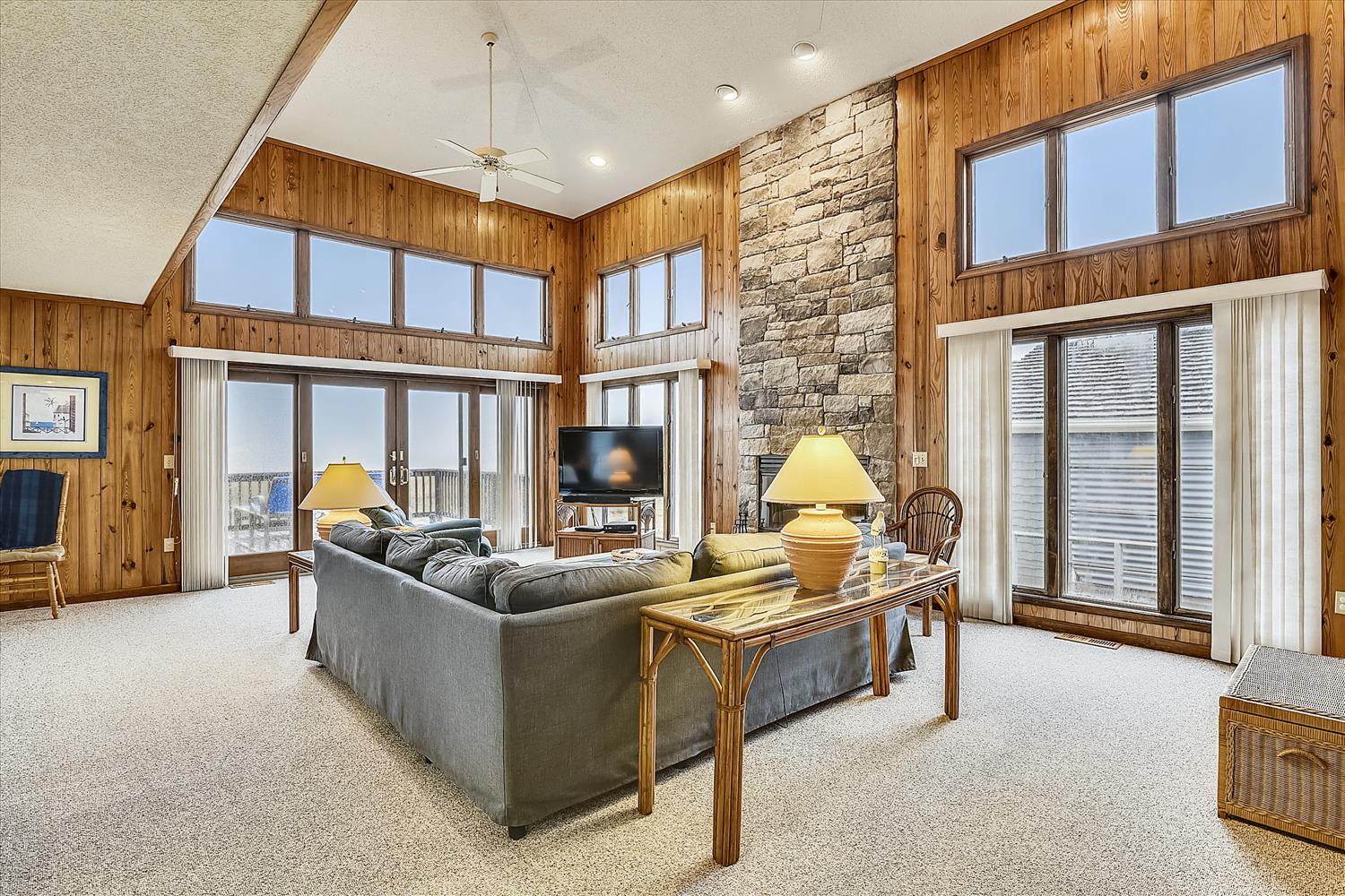 Settle into this bright, open living room where soaring ceilings and abundant natural light create a warm, welcoming space to unwind after your mountain adventures.
