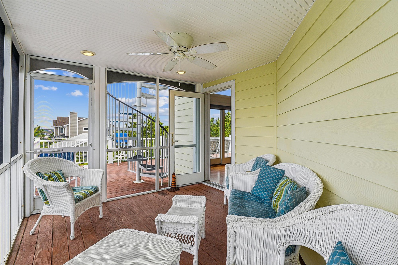 Relax in your screened porch with wicker seating and ceiling fan, overlooking the neighborhood. The perfect spot to unwind with morning coffee or an evening breeze.