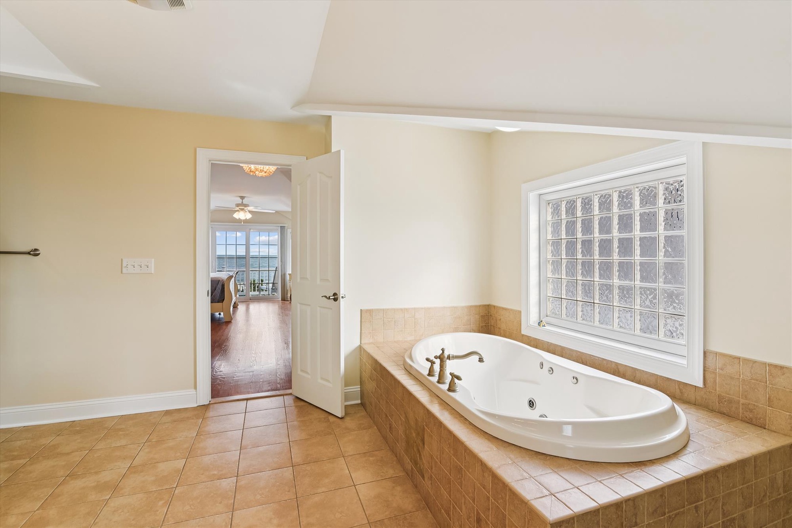 Soak away your cares in this spacious jetted tub with natural light, steps from your bedroom suite.