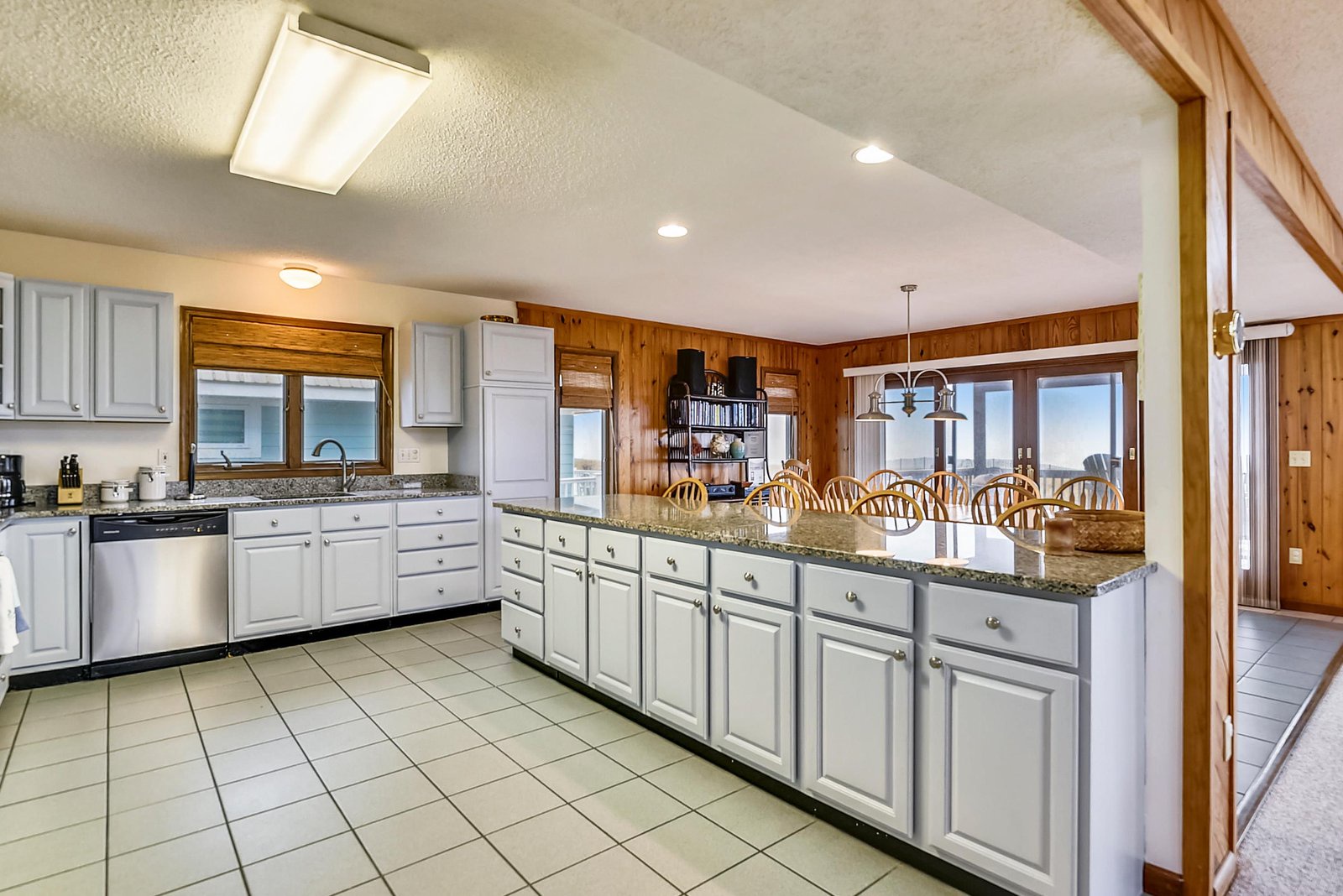 Your spacious kitchen flows seamlessly into a sun-drenched dining area, where ocean breezes drift through and every meal comes with a view.