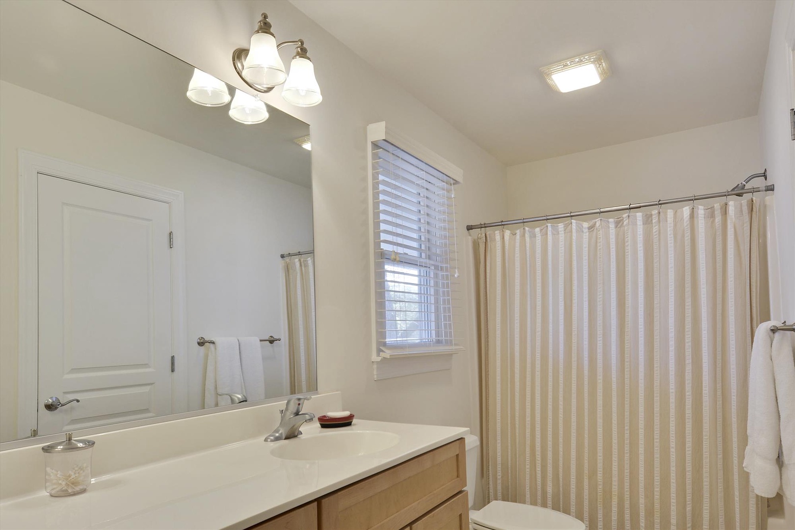 Unwind in your pristine bathroom with a relaxing soak in the tub-shower combo, complete with fresh towels and natural light.