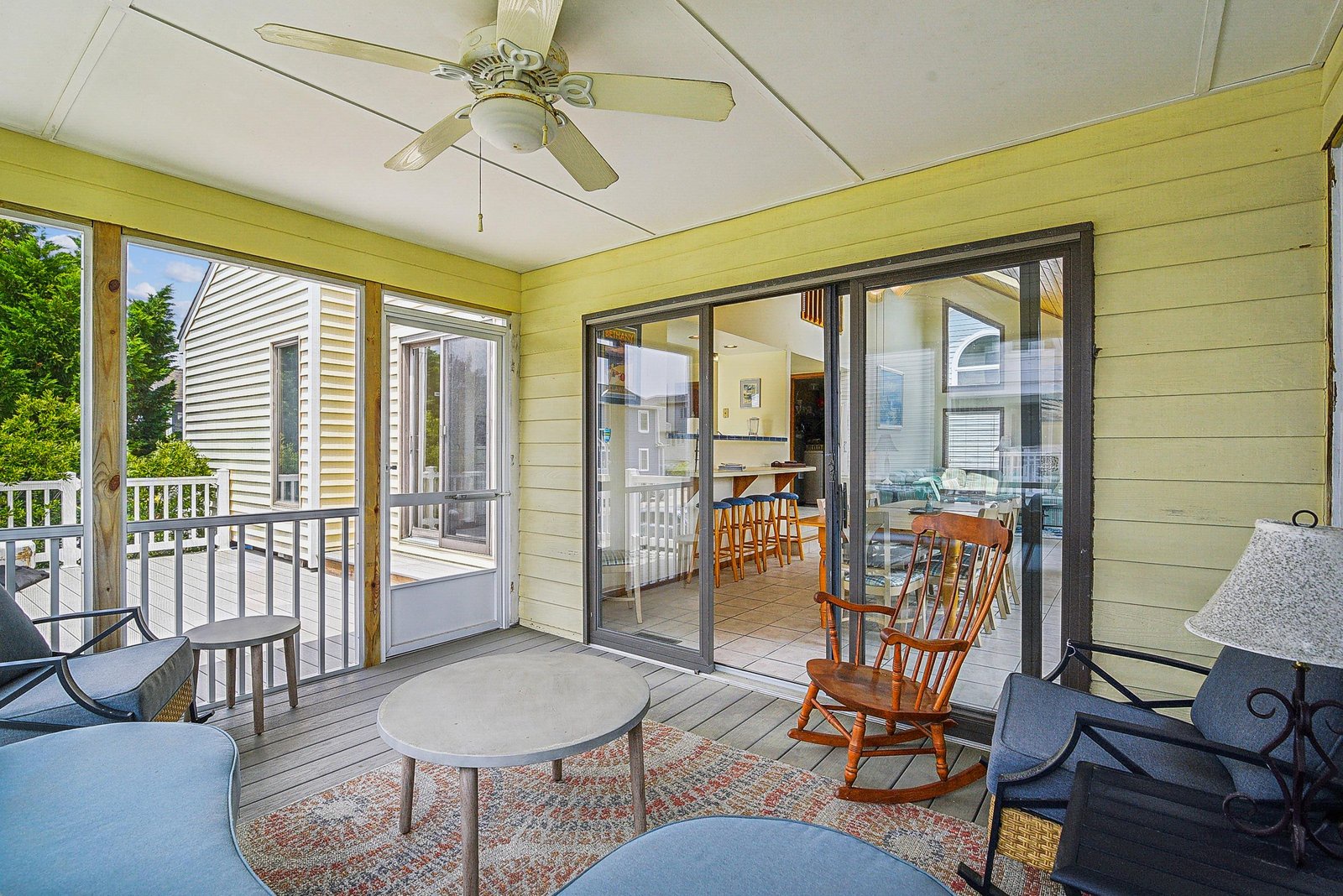Step onto your private screened porch and feel the gentle breeze as you rock in classic comfort. With cozy seating and easy access to the interior, this peaceful retreat invites you to unwind with morning coffee or evening conversations.