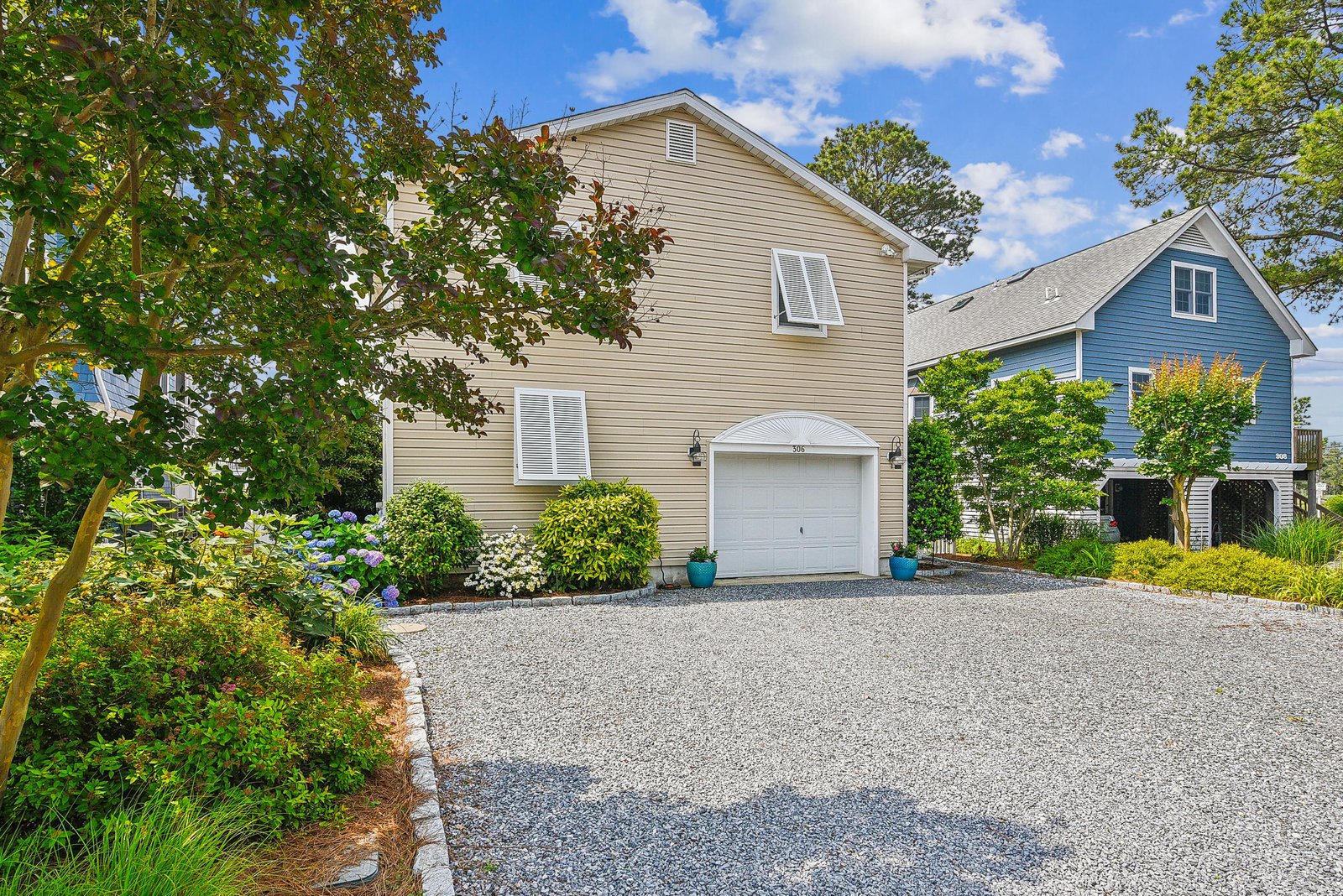 A welcoming property nestled in a peaceful neighborhood, surrounded by mature trees and colorful landscaping, with convenient off-street parking ready for your arrival.