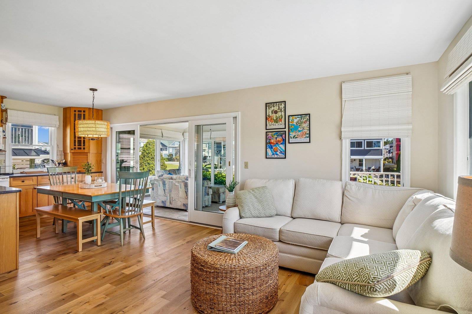 Sink into the plush sofa and feel instantly at home in this sun-drenched living space, where warm wood floors and coastal charm create your perfect retreat.