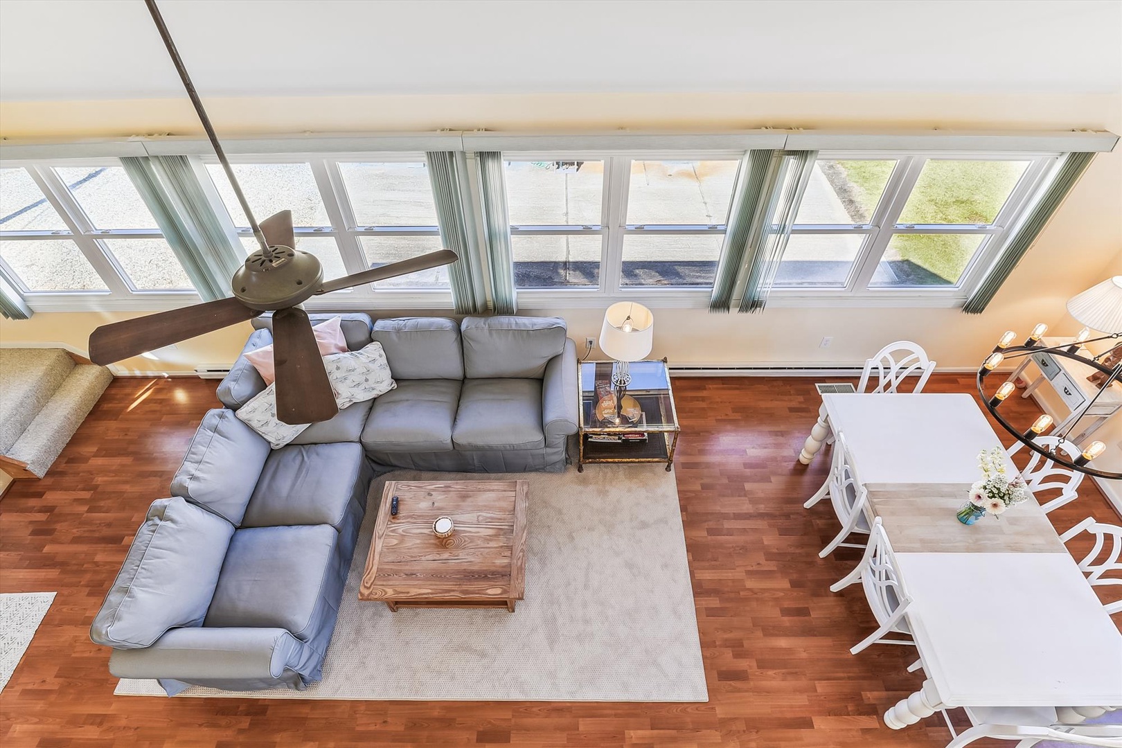 Stretch out on plush sectional sofas beneath vaulted ceilings and walls of windows that flood your living space with warm natural light. Your open-concept retreat blends comfort and style seamlessly.