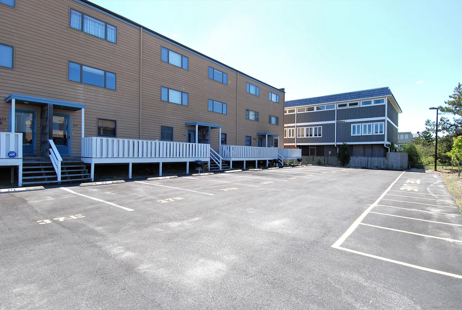 Multi-building vacation property featuring convenient on-site parking with clearly marked spaces for easy arrival and departure.
