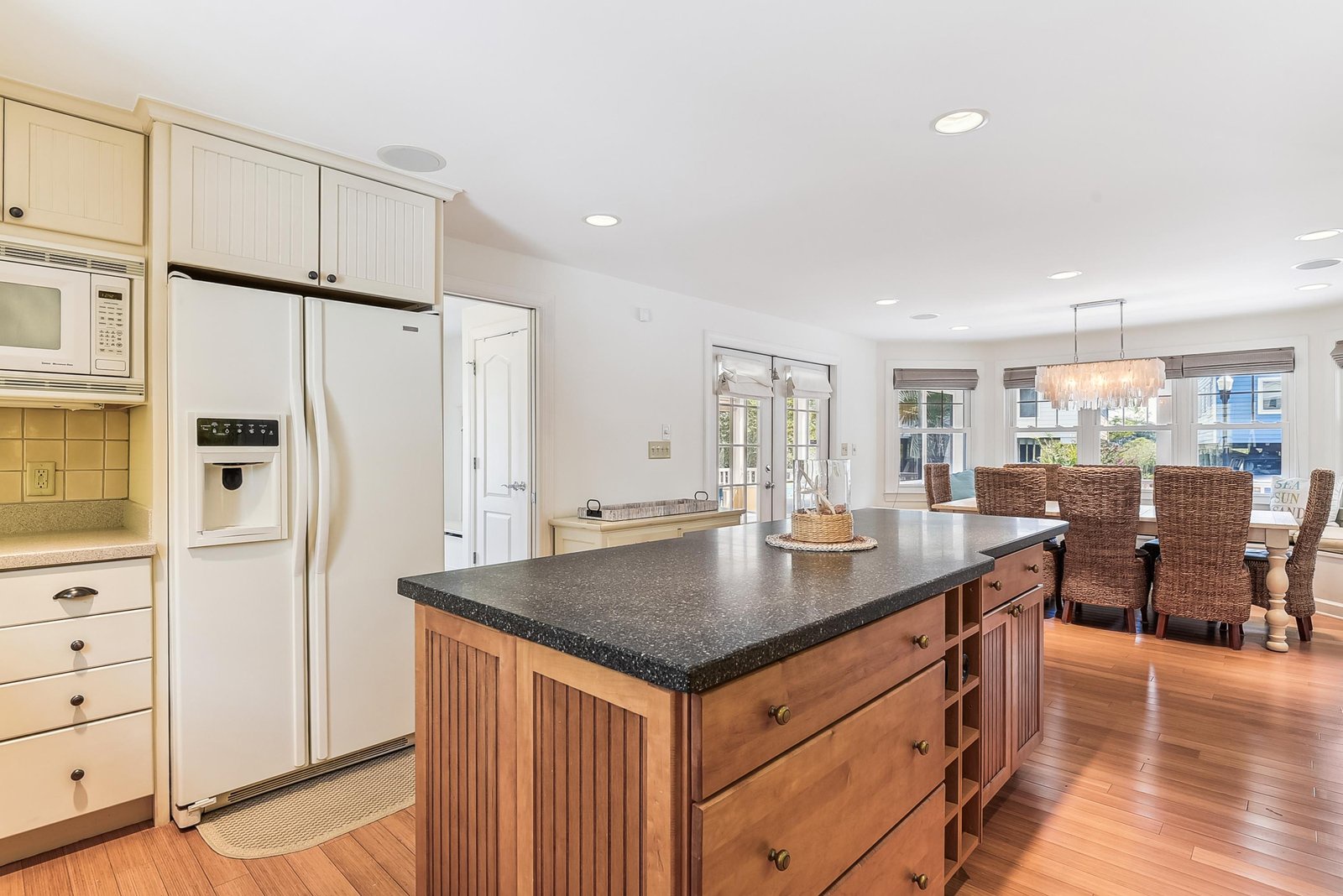 Spacious kitchen with granite countertops and a large island flows seamlessly into your bright dining area, perfect for family meals and gathering with friends.