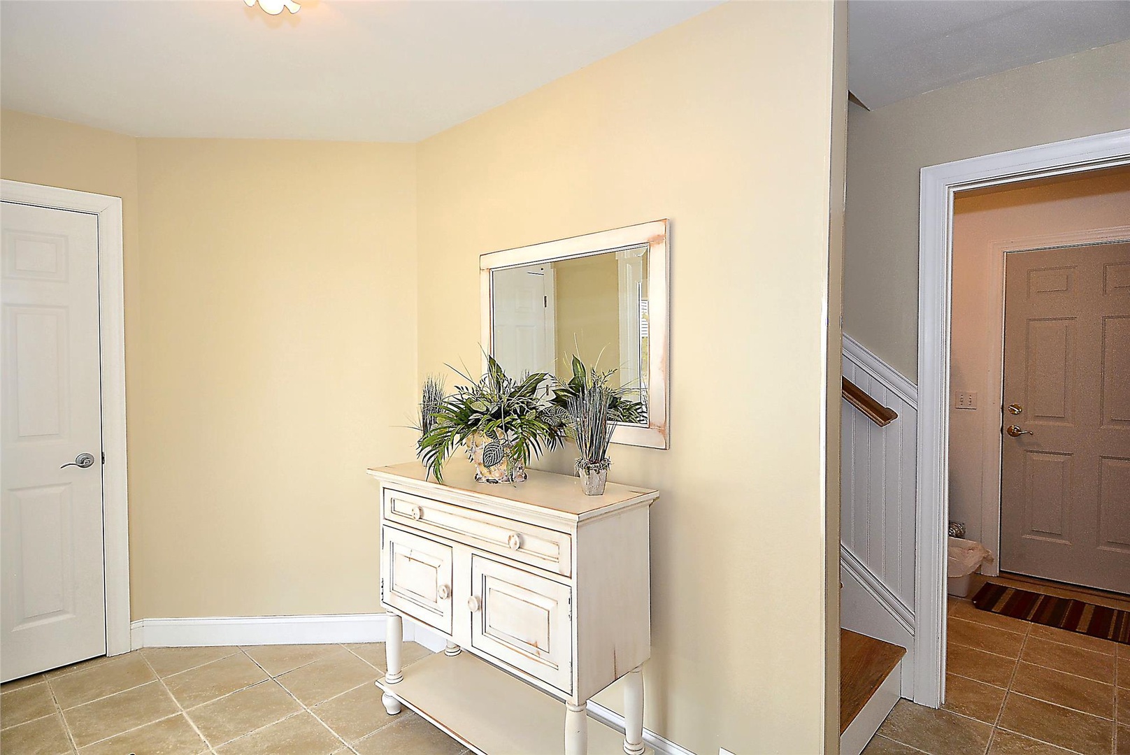 Step into your inviting entryway, where warm tones and coastal-inspired decor welcome you home after a day of adventure.