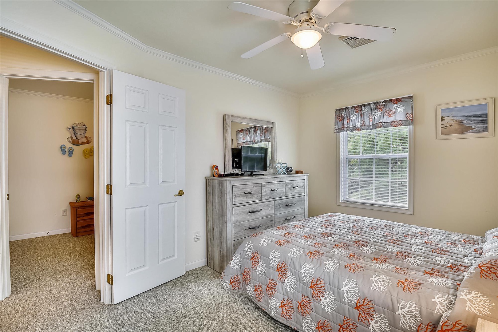 Unwind in your cozy bedroom with soft carpeting, a ceiling fan to keep you comfortable, and a dresser for all your belongings. Natural light fills the room, making it the perfect retreat.