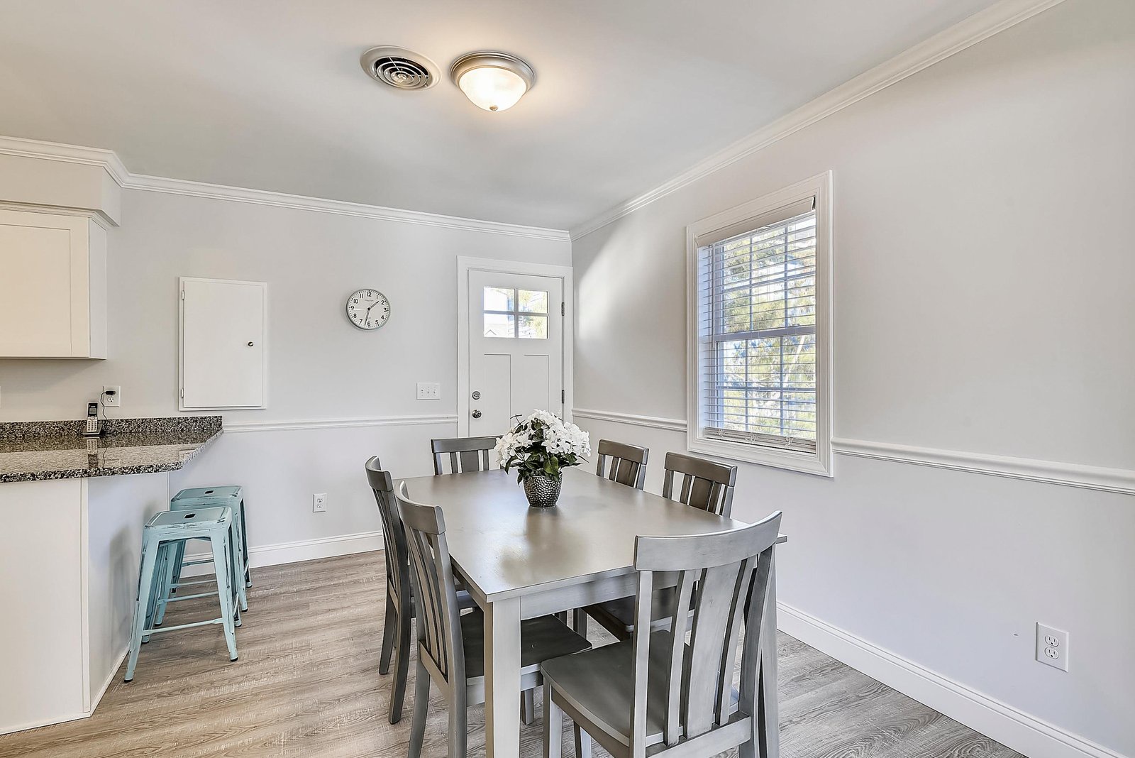 Step into a bright, welcoming dining space where you can share meals with loved ones. Natural light pours through the large windows, and there's plenty of room to gather around the table and create lasting memories.