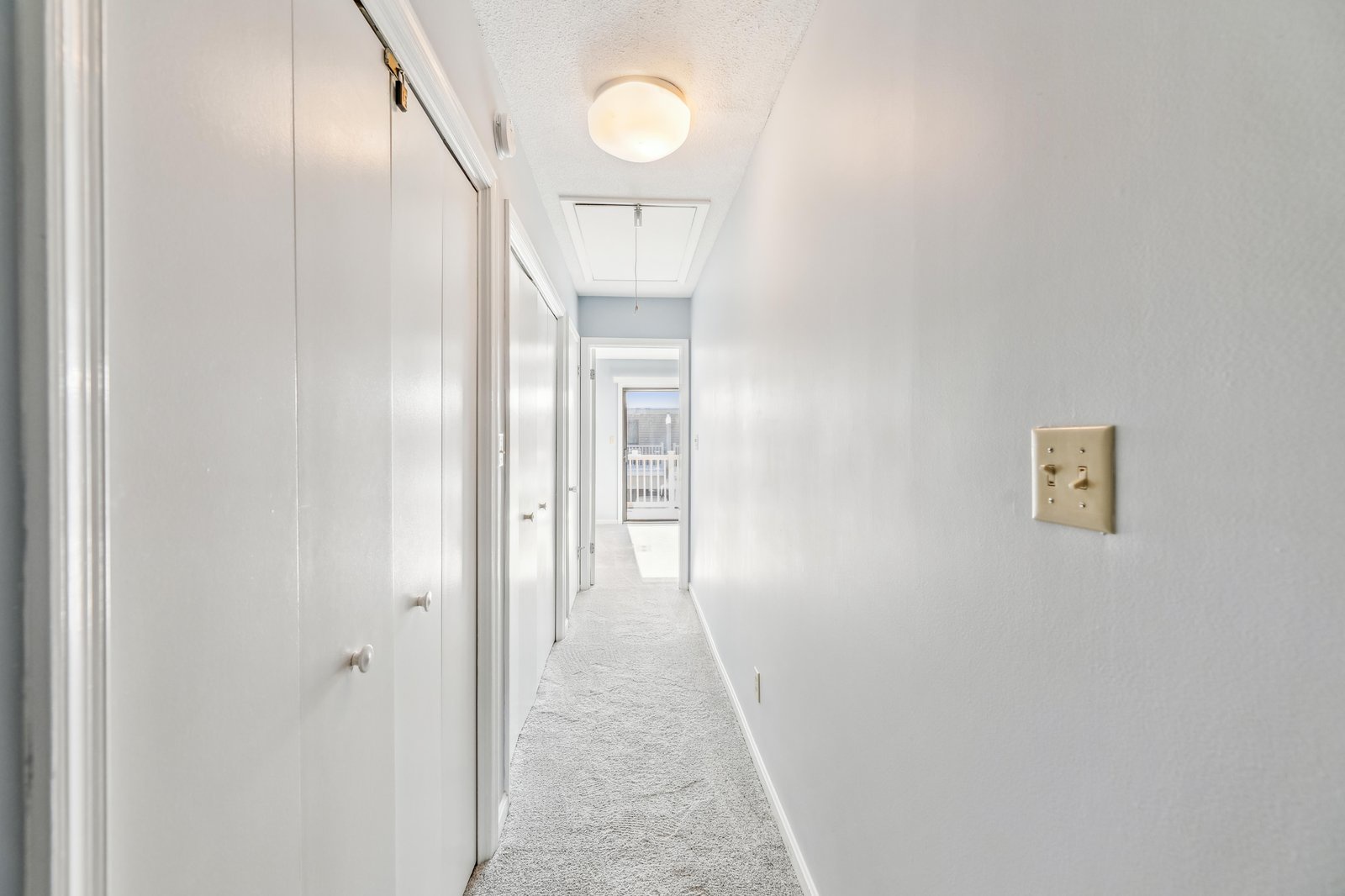 A bright hallway leads you through the space with soft lighting and doors to your private rooms waiting at every turn.