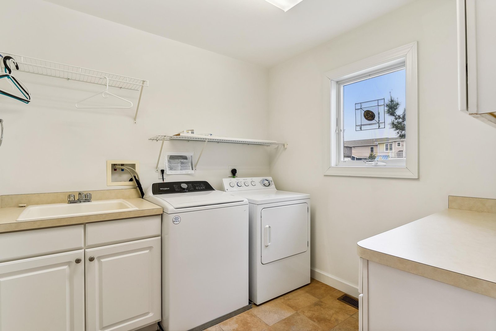 Handle laundry with ease in your own dedicated space—complete with full-size washer and dryer, a sink for hand-washing delicates, and plenty of counter and shelving to keep things tidy.