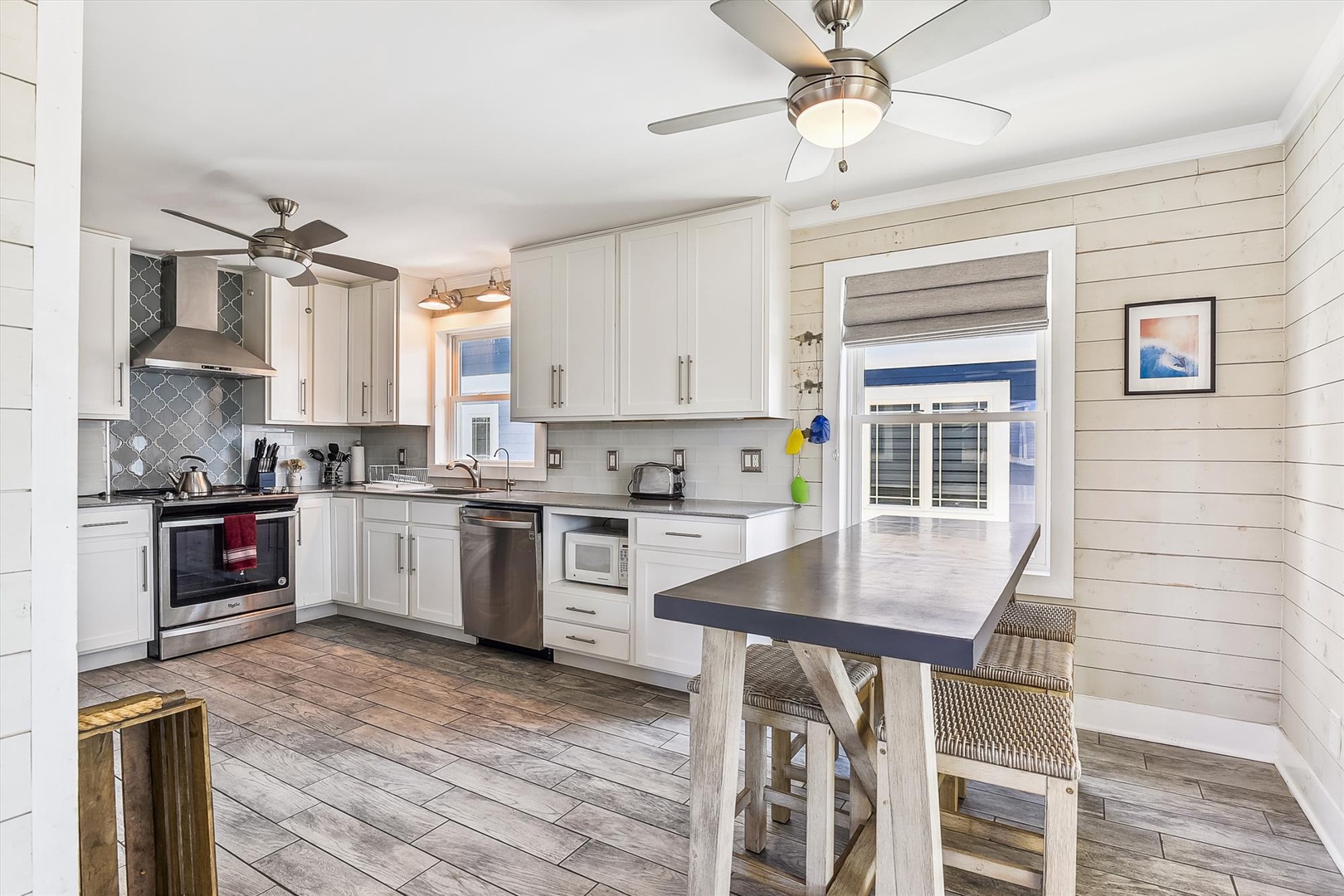 You'll love preparing meals in this bright, fully equipped kitchen with modern appliances, plenty of counter space, and coastal charm. Natural light floods the space, making it inviting and easy to cook together.