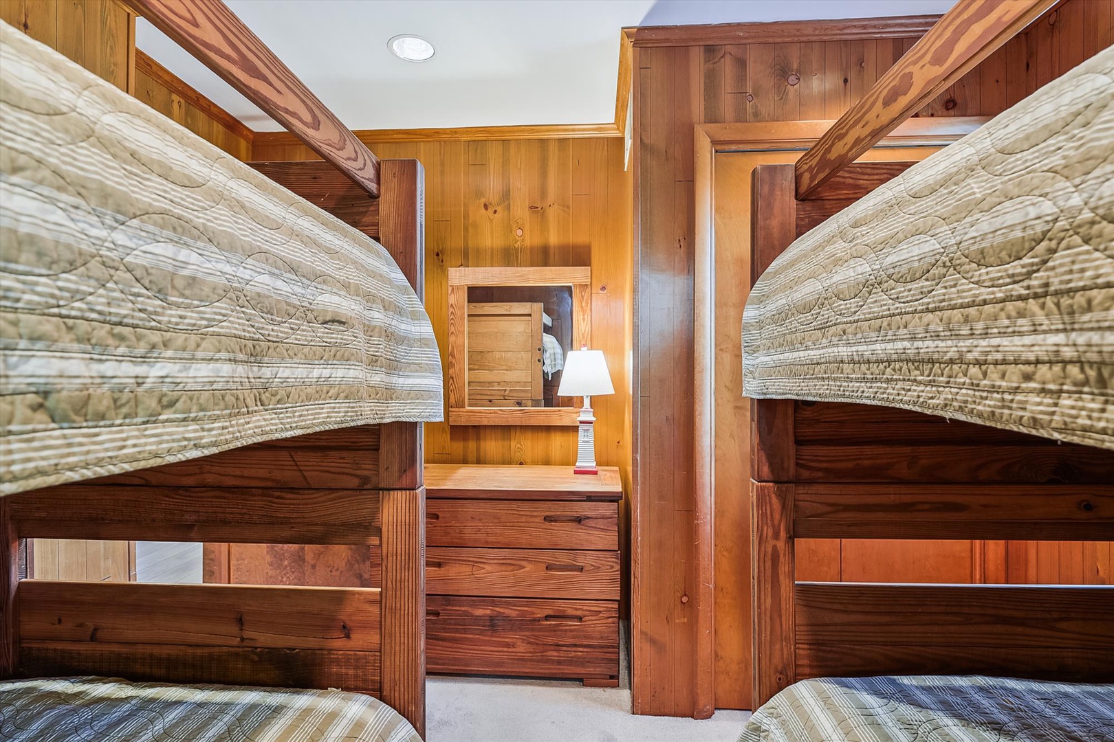 Charming bunk room with sturdy wooden beds and cozy linens—perfect for kids or groups sharing laughter and making memories together in your mountain getaway.